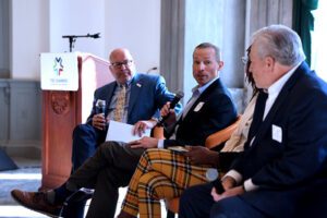 Seated and in discussion,  Matt Joyce, Jac Rivers, and Jeff Missan, 