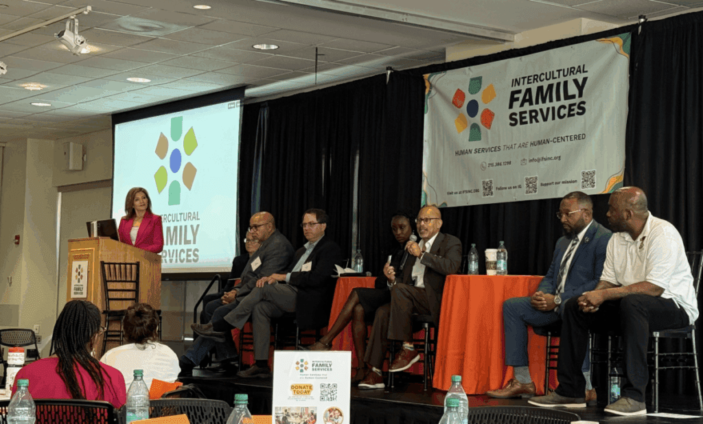 Panelists speaking on stage